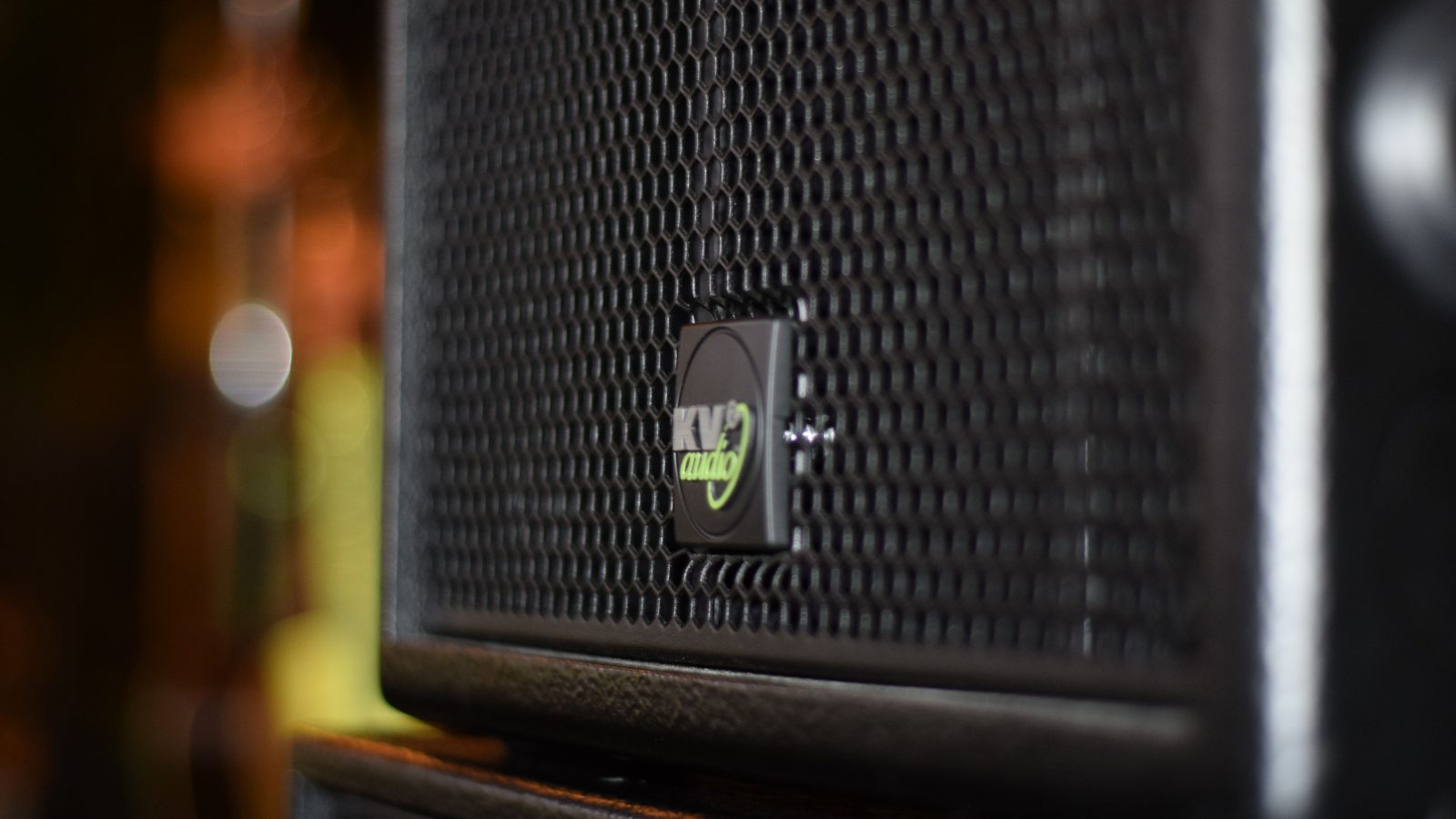 Close-up of a black PA speaker cabinet on stage