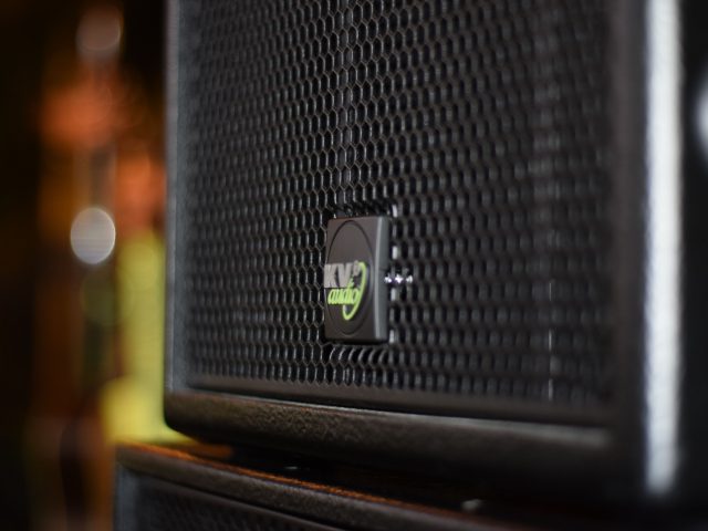 Close-up of a black PA speaker cabinet on stage